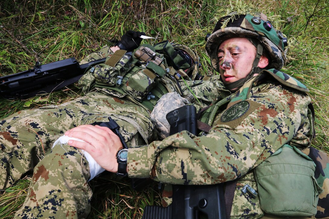 A Croatian soldier applies bandages to a simulated gunshot wound in a situational training lane during Immediate Response 15 in Slunj, Croatia, Sept. 13, 2015. Immediate Response 15 is a multinational, brigade-level, command post exercise utilizing computer-assisted simulations and field training exercises in Croatia and Slovenia. U.S. Army photo by Sgt. 1st Class Caleb Barrieau