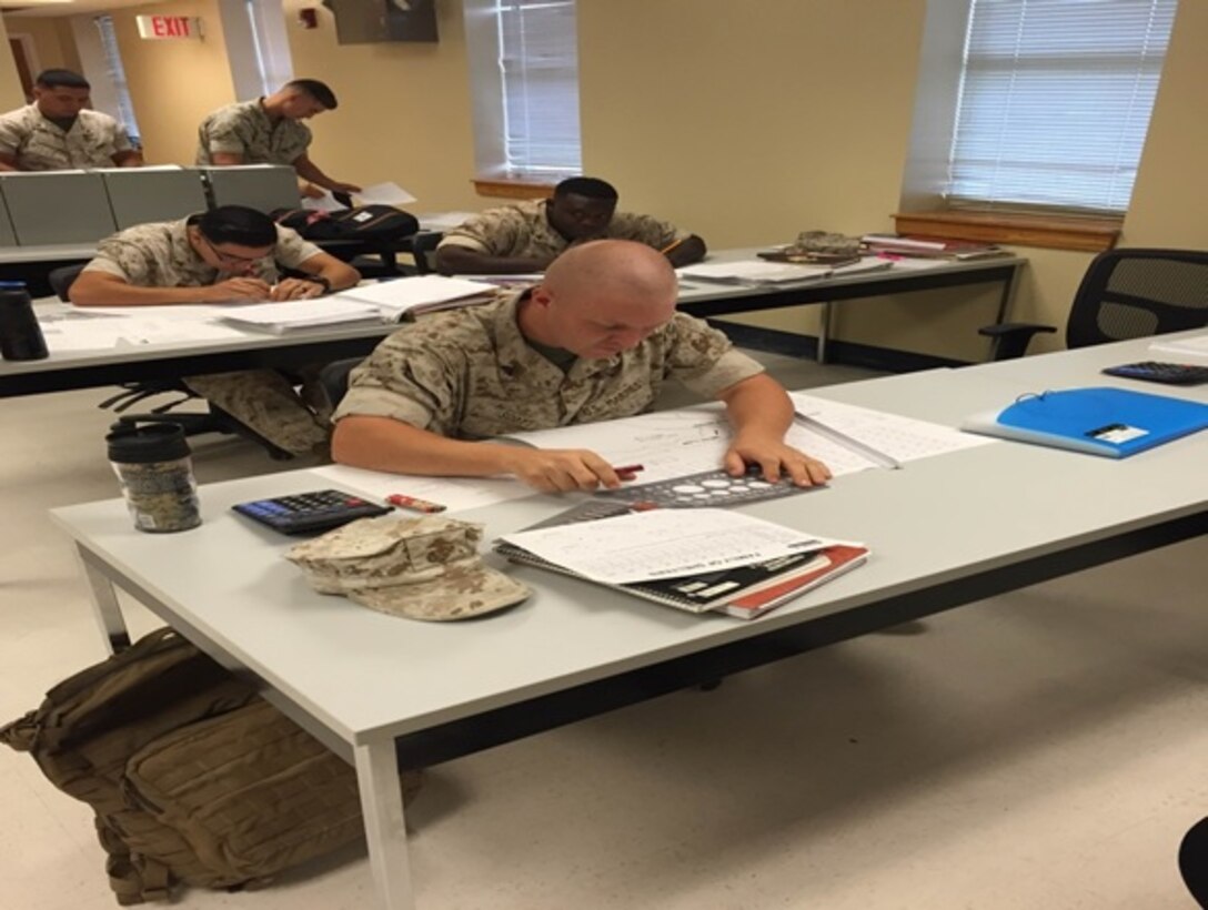 Cpl. Joseph Scott (forefront), and Marines attending the Advanced Electrician course 3-15 participate in a practical application exercise on field planning at Marine Corps Engineer School, Utilities Instruction Company, Camp Lejeune, North Carolina on August 31, 2015.  The planning stage for these Marines is crucial to their overall development as a small unit leader within their respective commands.  This exercise is intended to test the Marines knowledge on how to emplace generator sites, Mobile Electric Power Distribution Systems (MEPDIS), and general power requirements for field operations and combat deployment operations.    
