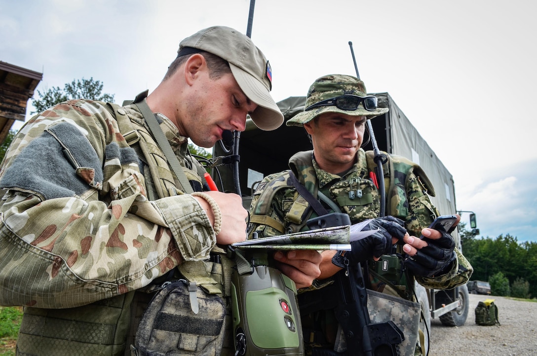 Croatian and Slovenian Joint Terminal Attack Controllers work together in a situational training lane during Immediate Response 15 in Slunj, Croatia, Sept. 10, 2015. Immediate Response 15 is a multinational, brigade-level, command post exercise utilizing computer-assisted simulations and field training exercises in Croatia and Slovenia. Photo by Joint Multinational Readiness Center