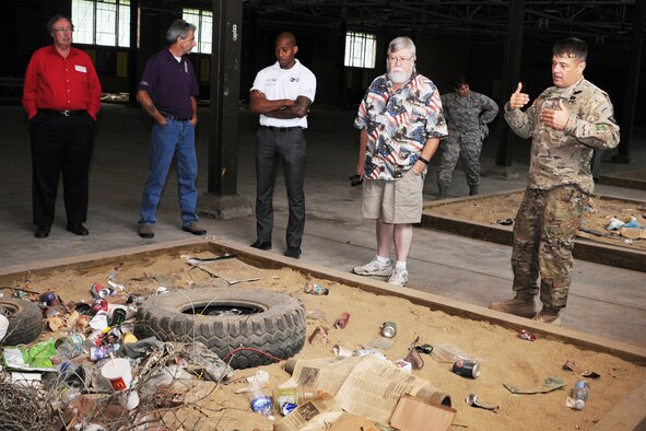 Ohio Army National Guard Master Sgt. Michael Frient, a Camp Ravenna non-commissioned range officer, talks with a group of attendees during the 3rd Annual Joint Employer Awareness Event in a World War II-era warehouse repurposed to house an Improvised Explosive Device (IED) recognition course here, Aug. 6, 2015. The two-day event, designed to give civilian employers of Air Force Reservists and Ohio National Guardsmen a better understanding of the mission their employees carry out as members of the U.S. Armed Forces, also gave attendees the opportunity to get an up-close look at both the Ohio National Guard's Joint Military Training Center here and the 910th Airlift Wing's facilities at nearby Youngstown Air Reserve Station, Ohio. (U.S. Air Force photo/Staff Sgt. Rachel Kocin)