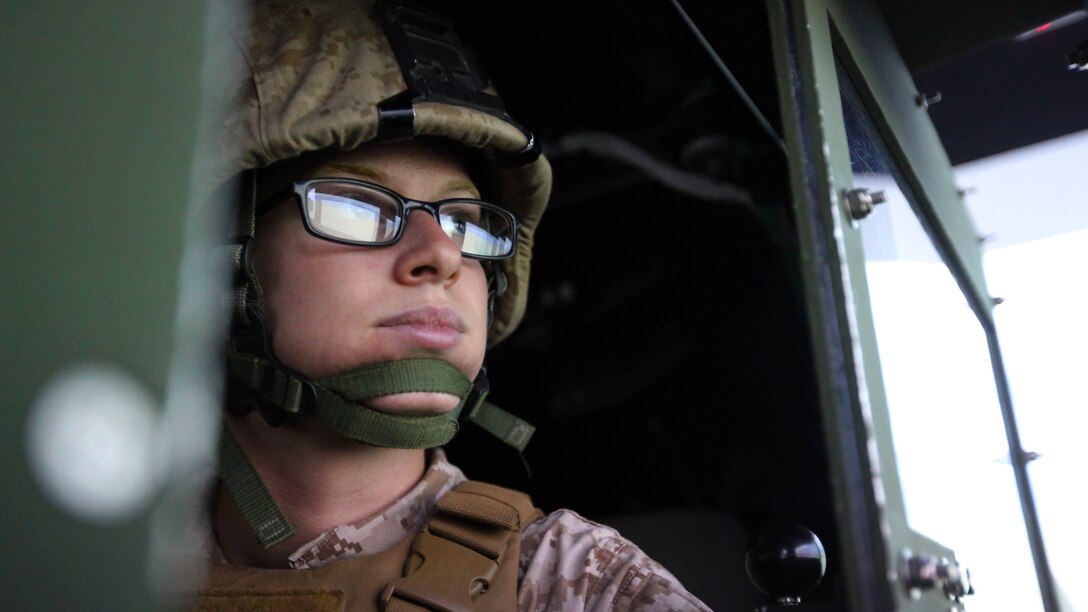 Pfc. Stephanie L. Brown scans the digital desert horizon during a combat convoy simulator at Marine Corps Base Camp Lejeune, N.C., Sept. 9, 2015. Marines with 2nd Low Altitude Air Defense Battalion tested their combat skills and decision making as they maneuvered through a simulated desert, mimicking the possible scenarios they could encounter while in a real-life scenario. The training simulator allowed the Marines to efficiently train in a controlled environment without sacrificing safety or accuracy. Brown is a low altitude air defense gunner with 2nd LAAD based out of Marine Corps Air Station Cherry Point, N.C. 