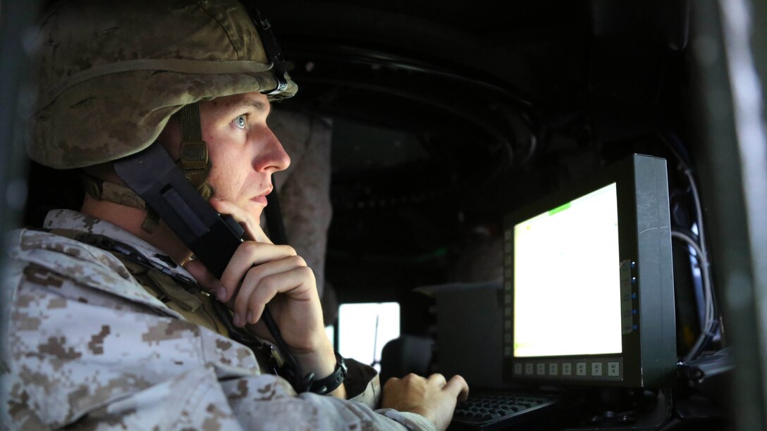 Cpl. Ian M. Keyser maintains communication with other convoy members during a combat convoy simulator at Marine Corps Base Camp Lejeune, N.C., Sept. 9, 2015. Marines with 2nd Low Altitude Air Defense Battalion tested their combat skills and decision making as they maneuvered through a simulated desert, mimicking the possible scenarios they could encounter while in a real-life scenario. The training simulator allowed the Marines to efficiently train in a controlled environment without sacrificing safety or accuracy. Keyser is a low altitude air defense gunner with 2nd LAAD based out of Marine Corps Air Station Cherry Point, N.C. 