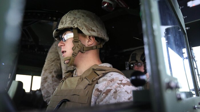 Pfc. William K. Blackwood communicates with members of his convoy during a combat convoy simulator at Marine Corps Base Camp Lejeune, N.C., Sept. 9, 2015. Marines with 2nd Low Altitude Air Defense Battalion tested their combat skills and decision making as they maneuvered through a simulated desert, mimicking the possible scenarios they could encounter while in a real-life scenario. The training simulator allowed the Marines to efficiently train in a controlled environment without sacrificing safety or accuracy. Blackwood is a low altitude air defense gunner with 2nd LAAD based out of Marine Corps Air Station Cherry Point, N.C. 