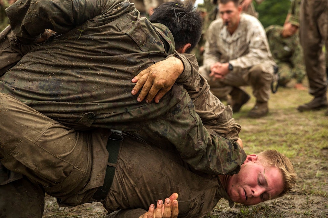 U.S. Marine Corps Lance Cpl. Justin Peterson grapples with a Japan Ground Self-Defense Force soldier during Exercise Forest Light 16 at Camp Aibano, Japan, Sept. 10, 2015. Peterson is an infantry rifleman with the 2nd Marine Regiment. U.S. Marine Corps photo by Cpl. Carlos Cruz Jr.
