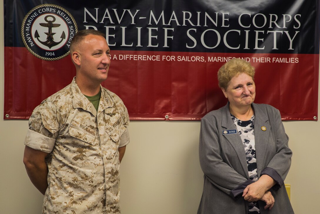Col. Peter D. Buck congratulates Pam Mentzer during a celebration of her 20-year anniversary of employment with the Navy Marine Corps Relief Society aboard Marine Corps Air Station Beaufort Sept. 1. Her history of volunteer work with NMCRS goes back to 1980.  Mentzer is the director of NMCRS aboard the air station. Buck is the commanding officer of MCAS Beaufort.