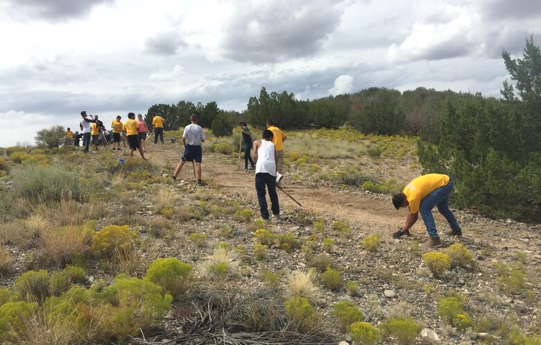 COCHITI LAKE, N.M. – Volunteers from the JROTC at Albuquerque's West Mesa High School work on a hiking trail at the project, Sept. 5, 2015.  The trail connects the Visitors Center with the swim beach.
