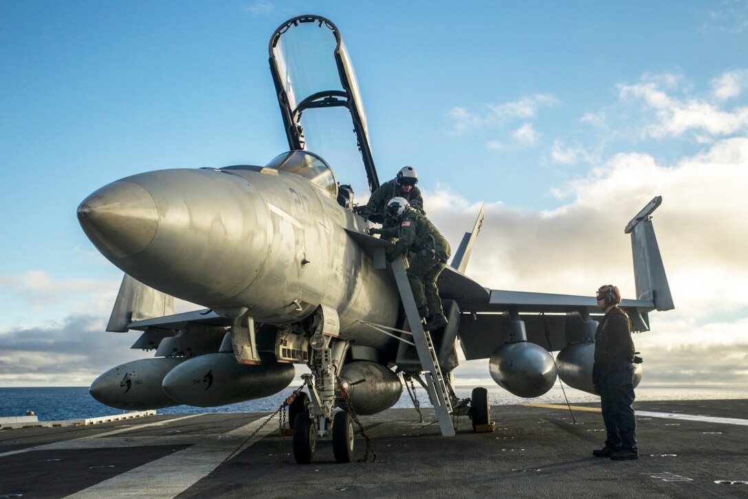Navy Rear Adm. Lisa Franchetti and Cmdr. Michael Stokes disembark from an F/A-18E Super Hornet on the flight deck of the aircraft carrier USS George Washington in the Pacific Ocean, Sept. 14, 2015. Franchetti is commander of Carrier Strike Group 9, and Stokes is commanding officer of Strike Fighter Squadron 137. U.S. Navy photo by Petty Officer 3rd Class Bryan Mai