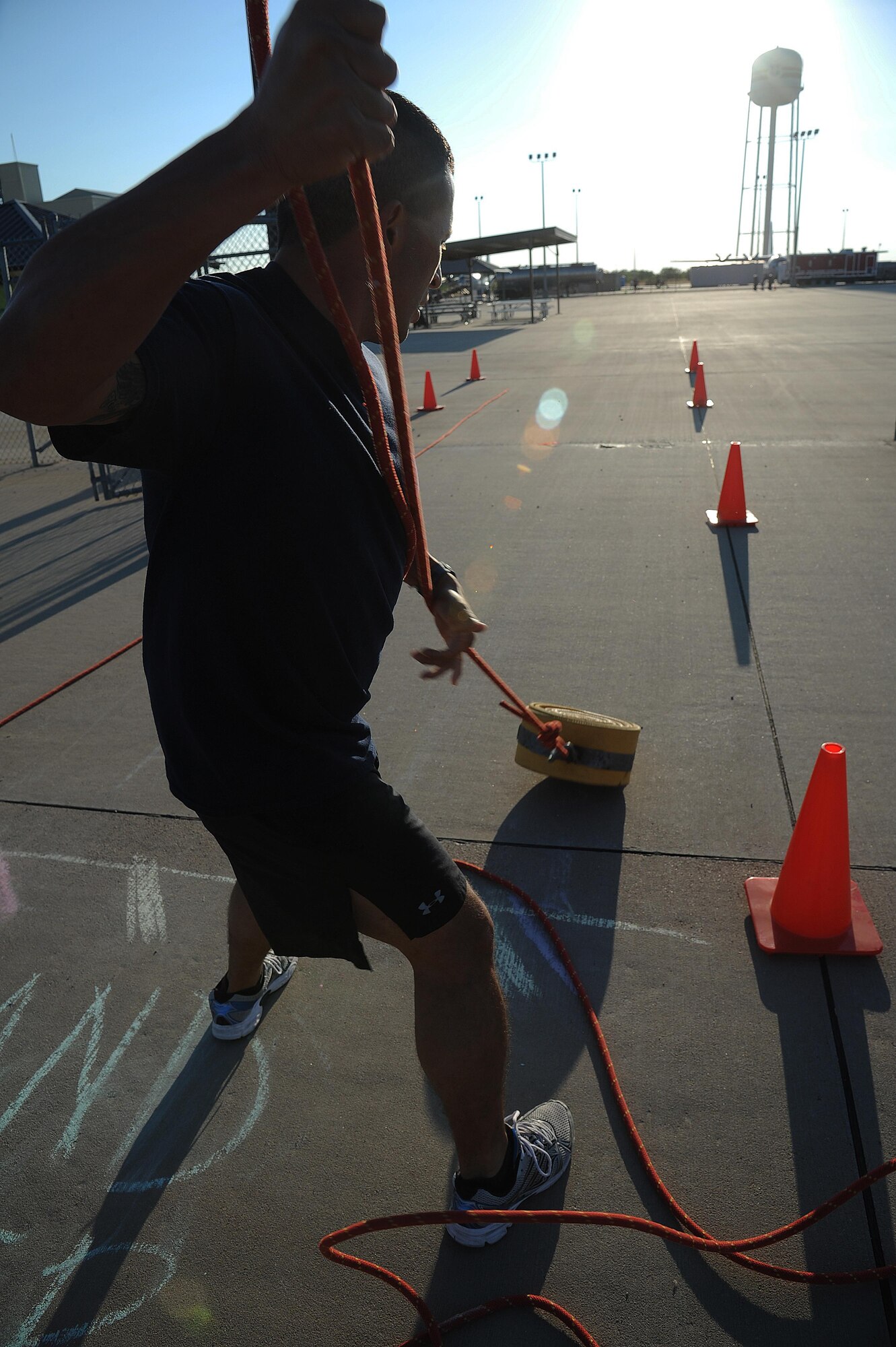 Chappa Davis, San Angelo SWAT patrol officer, pulls a rolled up fire hose by a rope during the Blood, Sweat and Stairs Competition at Goodfellow Air Force Base, Sept. 12, 2015. The Louis F. Garland Department of Defense Fire Academy welcomed the local emergency responders to participate in the event. (U.S. Air Force photo by Airman Caelynn Ferguson/Released)