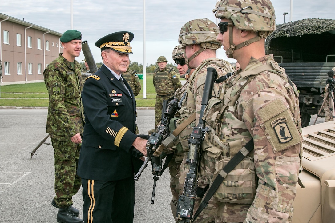 U.S. Army Gen. Martin Dempsey, chairman of the Joint Chiefs of Staff, presents coins of to U.S. soldiers during a visit to Tapa Military Base in Tapa, Estonia, Sept. 15, 2015. U.S. Army photo by Sgt. 1st Class Joshua S. Brandenburg