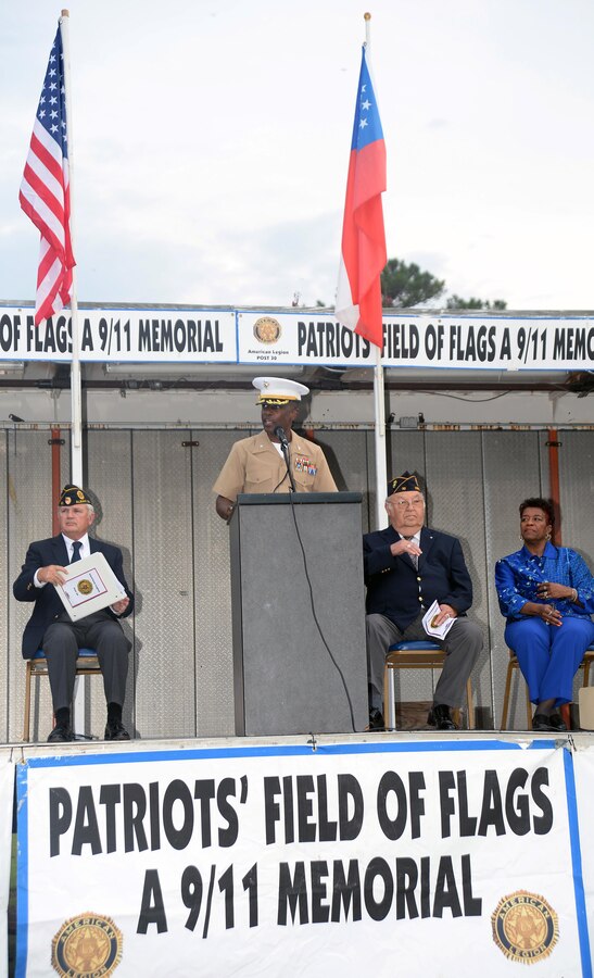 Col. James C. Carroll III, commanding officer, Marine Corps Logistics Base Albany, joins members of the community, both young and old, military members, veterans, first responders and local dignitaries to pay tribute to those who lost their lives during the tragic events of 9/11. The Patriots Field of Flags is an annual event sponsored by American Legion Post 30 and for the 14th year, was held in front of the Albany Mall, Sept. 11.