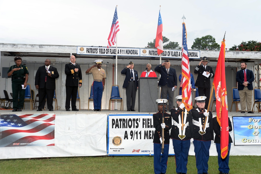 Col. James C. Carroll III, commanding officer, Marine Corps Logistics Base Albany, joins members of the community, both young and old, military members, veterans, first responders and local dignitaries to pay tribute to those who lost their lives during the tragic events of 9/11. The Patriots Field of Flags is an annual event sponsored by American Legion Post 30 and for the 14th year, was held in front of the Albany Mall, Sept. 11.
