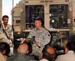 Army Sgt. Gilbert Britto of the California National Guard's Alpha Company, 640th Aviation Support Battalion, shows a class of Iraqi army personnel how to connect a fueling nozzle to the fueling module on a Heavy Expanded Mobility Tactical Truck at Camp Taji, Iraq, Sept. 13, 2011. The 640th conducted a weeklong course for the Iraqi Security Forces to prepare them to take over fueling operations once the California Guard unit departs theater.