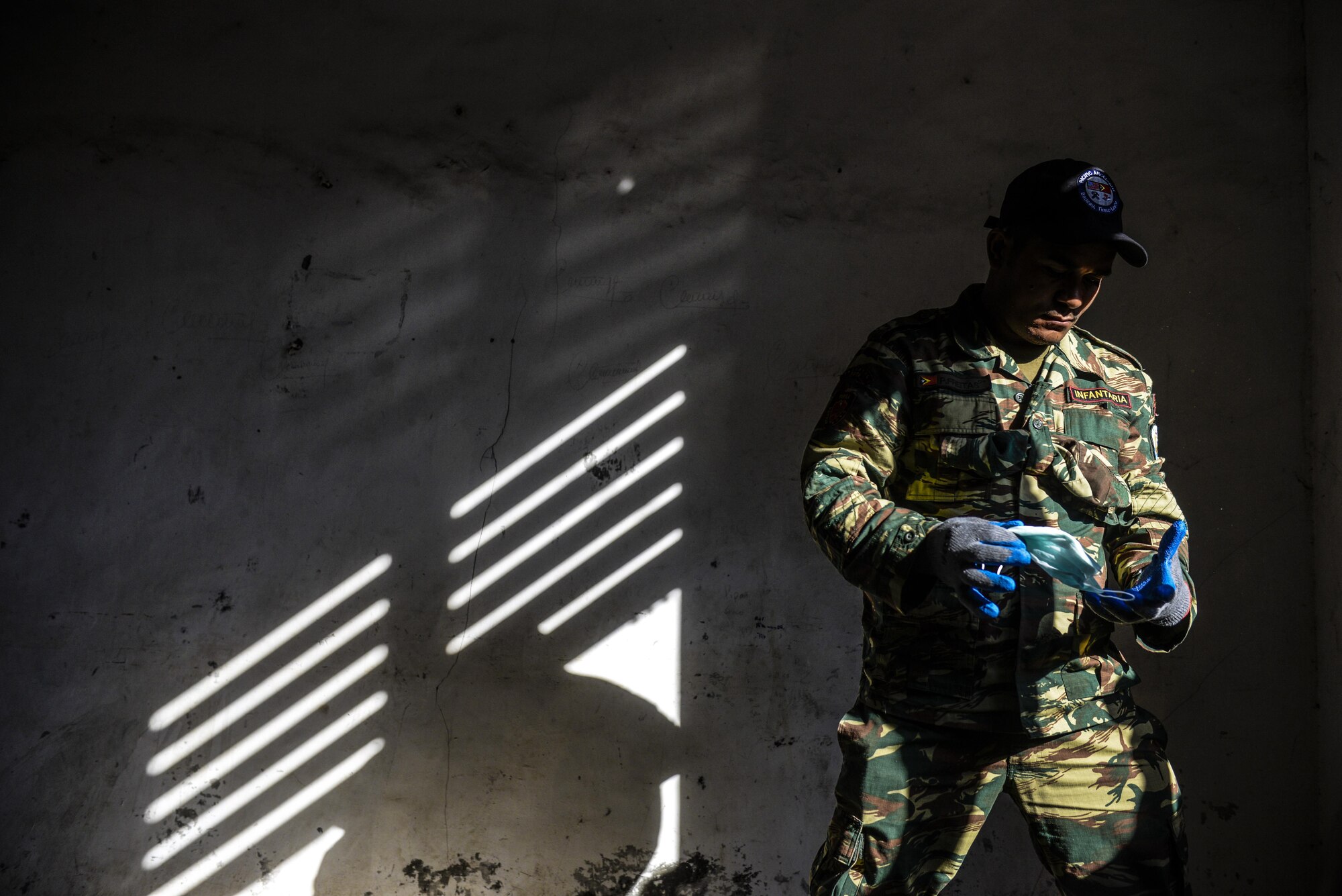 A soldier of the Falintil-Forças de Defesa de Timor-Leste puts on protective gear during engineering project as part of Operation Pacific Angel 15-2, Sept. 5, 2015 in Baucau, Timor-Leste. Pacific Angel is a multilateral humanitarian assistance civil military operation, which improves military-to-military partnerships in the Pacific while also providing medical health outreach, civic engineering projects and subject matter exchanges among partner forces. (U.S. Air Force photo by Staff. Sgt. Alexander W. Riedel/Released)