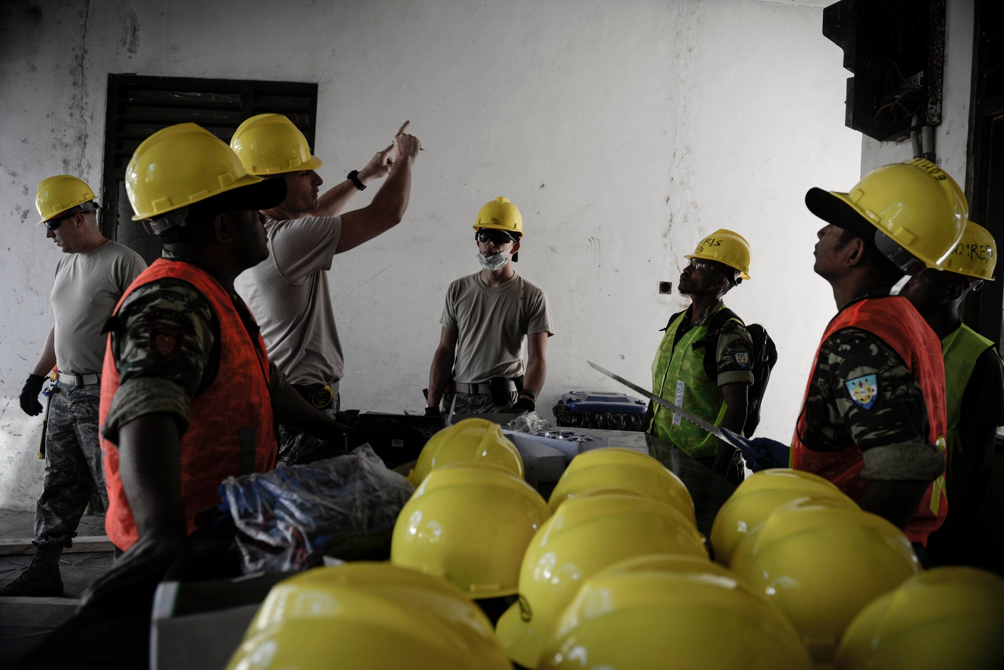 U.S. Airmen and soldiers of the Falintil-Forças de Defesa de Timor-Leste discuss construction plans during Operation Pacific-Angel 15-2, Sept. 5, 2015 in Baucau, Timor-Leste. Pacific Angel is a multilateral humanitarian assistance civil military operation, which improves military-to-military partnerships in the Pacific while also providing medical health outreach, civic engineering projects and subject matter exchanges among partner forces. (U.S. Air Force photo by Staff. Sgt. Alexander W. Riedel/Released)