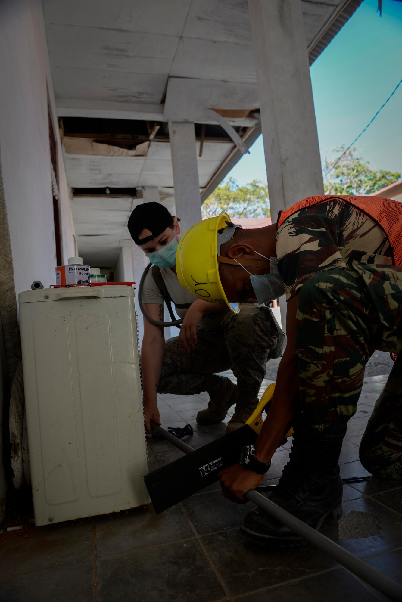 Senior Airman Blake Brooks, Pacific Angel 15-2 plumber, shortens a pipe with the help of Private Vitorino de Jesus Pereira, a soldier with Falintil Forças de Defesa de Timor-Leste, during a PACANGEL engineering project Sept. 5, 2015, in Baucau, Timor-Leste. Efforts undertaken during Pacific Angel help multilateral militaries in the Pacific improve and build relationships across a wide spectrum of civic operations, which bolsters each nation’s capacity to respond and support future humanitarian assistance and disaster relief operations. (U.S. Air Force photo by Staff Sgt. Alexander W. Riedel/Released)