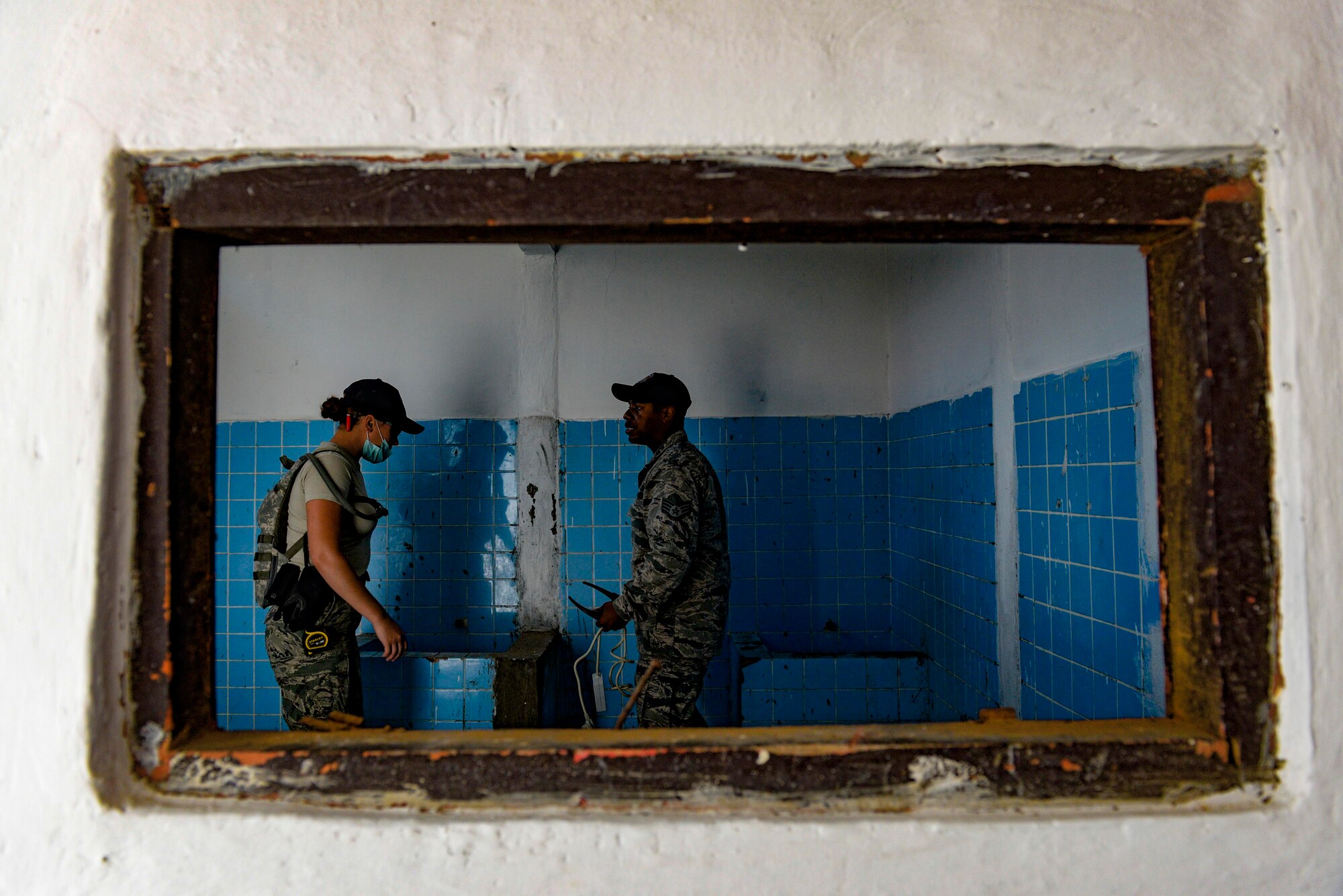 Senior Airman Blake Brooks, left, and Staff Sgt. Emenike Williams, both Pacific Angel 15-2 engineers, discuss work to be completed in a restroom of a medical university building, during a Pacific Angel engineering project Sept. 9, 2015, in Baucau, Timor-Leste. Efforts undertaken during Pacific Angel help multilateral militaries in the Pacific improve and build relationships across a wide spectrum of civic operations, which bolsters each nation’s capacity to respond and support future humanitarian assistance and disaster relief operations. (U.S. Air Force photo by Staff Sgt. Alexander W. Riedel/Released)