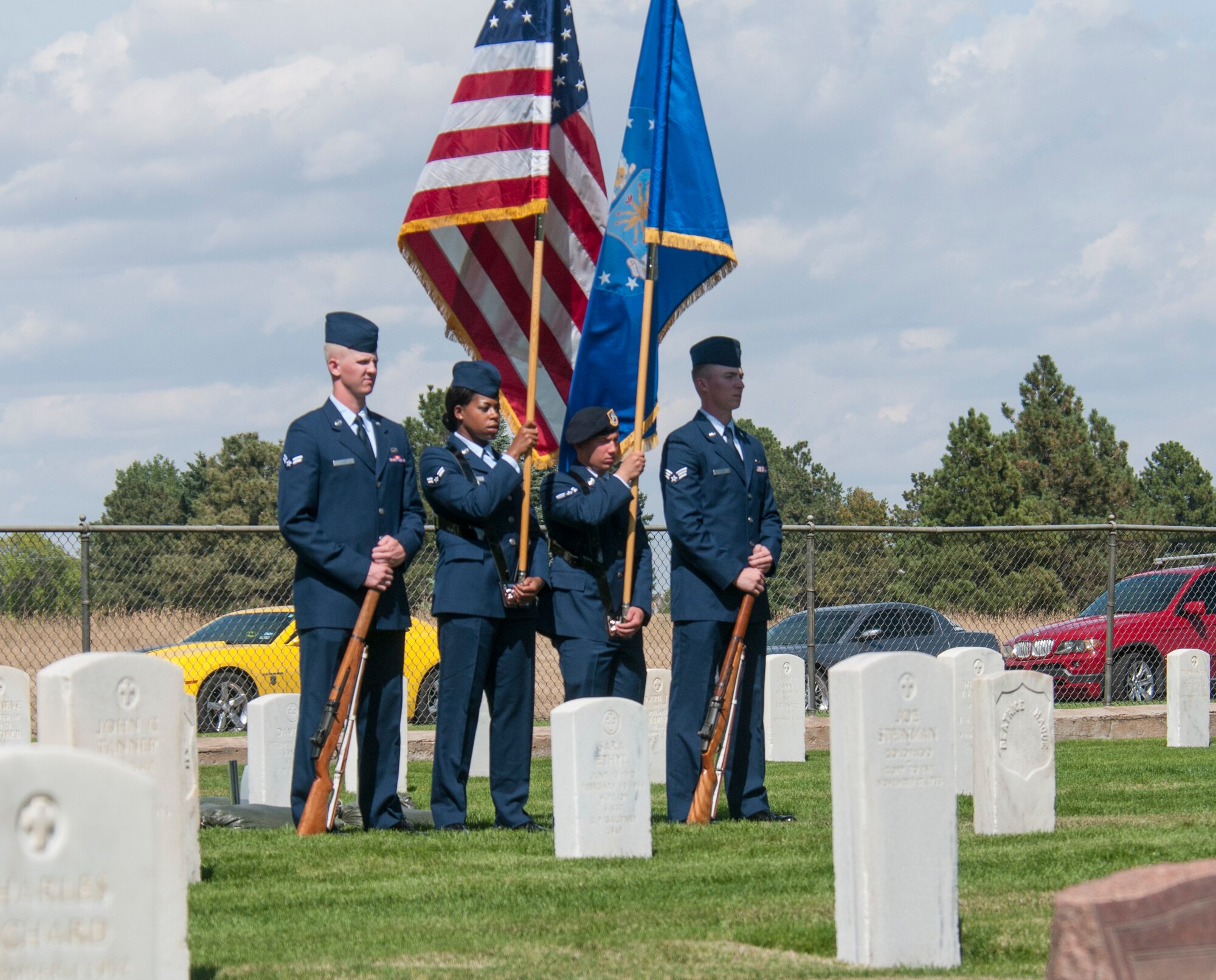 A colors team stands in the F.E. Warren Air Force Base, Wyo., cemetery Sept. 11, 2015, during a ceremony welcoming the base’s newest ceremonial guardsmen into the 90th Missile Wing Honor Guard. Flag details are one of several functions honor guards perform including rifle party, bearers and buglers. (U.S. Air Force photo by Senior Airman Jason Wiese)