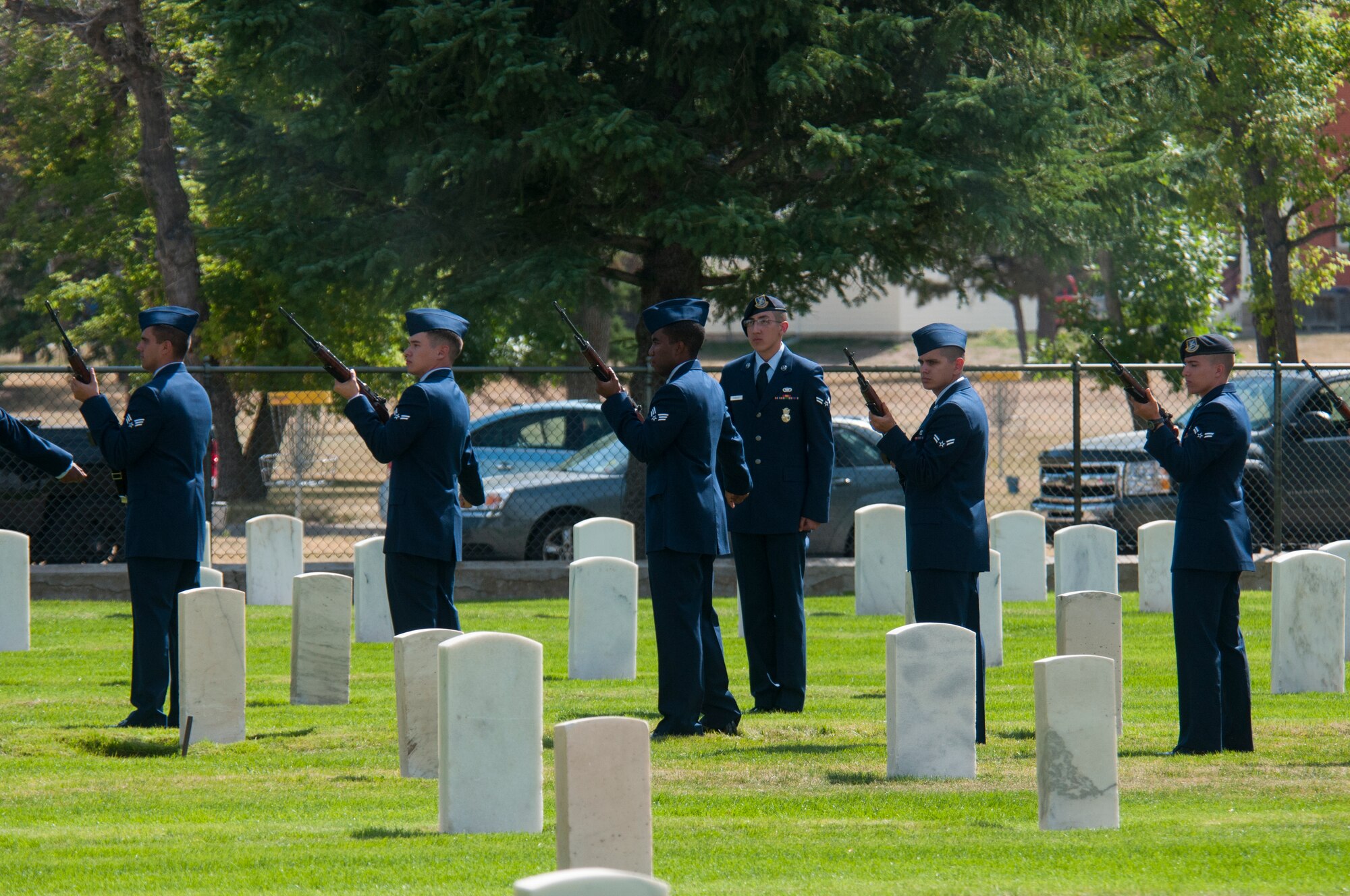 A team of new ceremonial guardsmen from the 90th Missile Wing prepare to fire a volley during a display of their role in a military funeral Sept. 11, 2015, in the F.E. Warren Air Force Base, Wyo., cemetery. The demonstration was part of the Airmen’s graduation, marking the end of their training to join the honor guard. (U.S. Air Force photo by Senior Airman Jason Wiese)