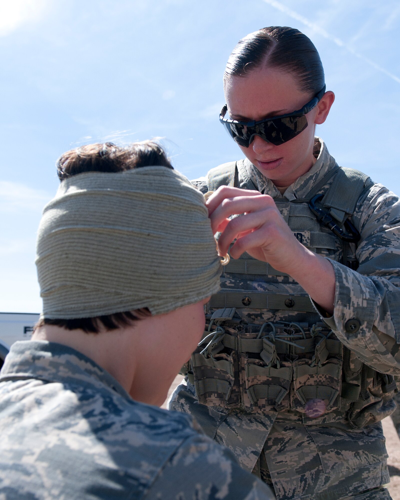 Airman 1st Class Samantha Frydenlund, 790th Missile Security Forces Squadron member, performs self-aid buddy care during the SABC portion of the 2015 Crow Creek Challenge, Sept. 11, 2015, on F.E. Warren Air Force Base, Wyo. Each team were presented with three injured Airmen scenarios to overcome and were evaluated on how well they followed the procedures. (U.S. Air Force photo by Airman 1st Class Malcolm Mayfield)