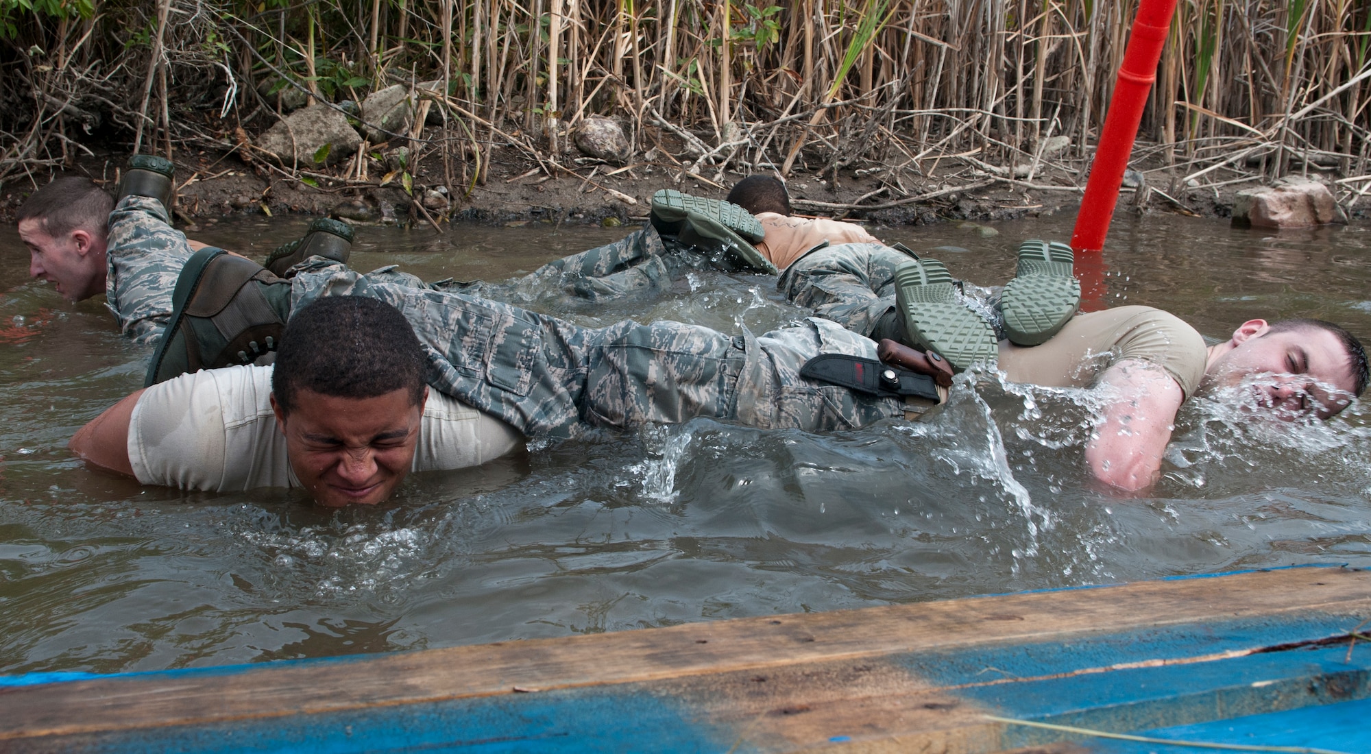 Airmen do four-man during the Team Pain portion of the 2015 Crow Creek Challenge, Sept. 11, 2015, on F.E. Warren Air Force Base, Wyo. This event consisted of five four-man push-ups, a tire flips for 25-meters and a log carry of 25-meters. (U.S. Air Force photo by Airman 1st Class Malcolm Mayfield)