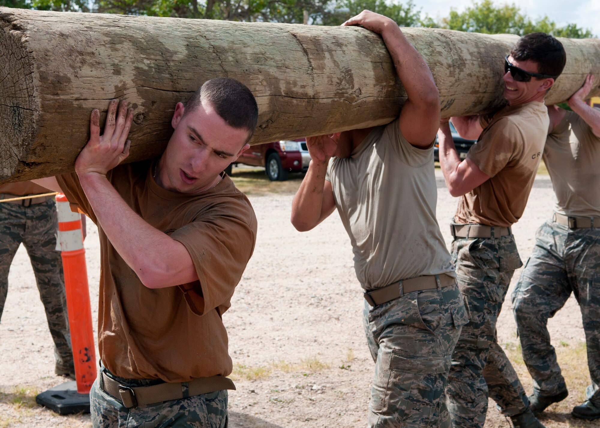 Airmen perform as a team during the Team Pain portion of the 2015 Crow Creek Challenge, Sept. 11, 2015, on F.E. Warren Air Force Base, Wyo. This event consisted of five four-man push-ups, a tire flips for 25-meters and a log carry of 25-meters. (U.S. Air Force photo by Airman 1st Class Malcolm Mayfield)