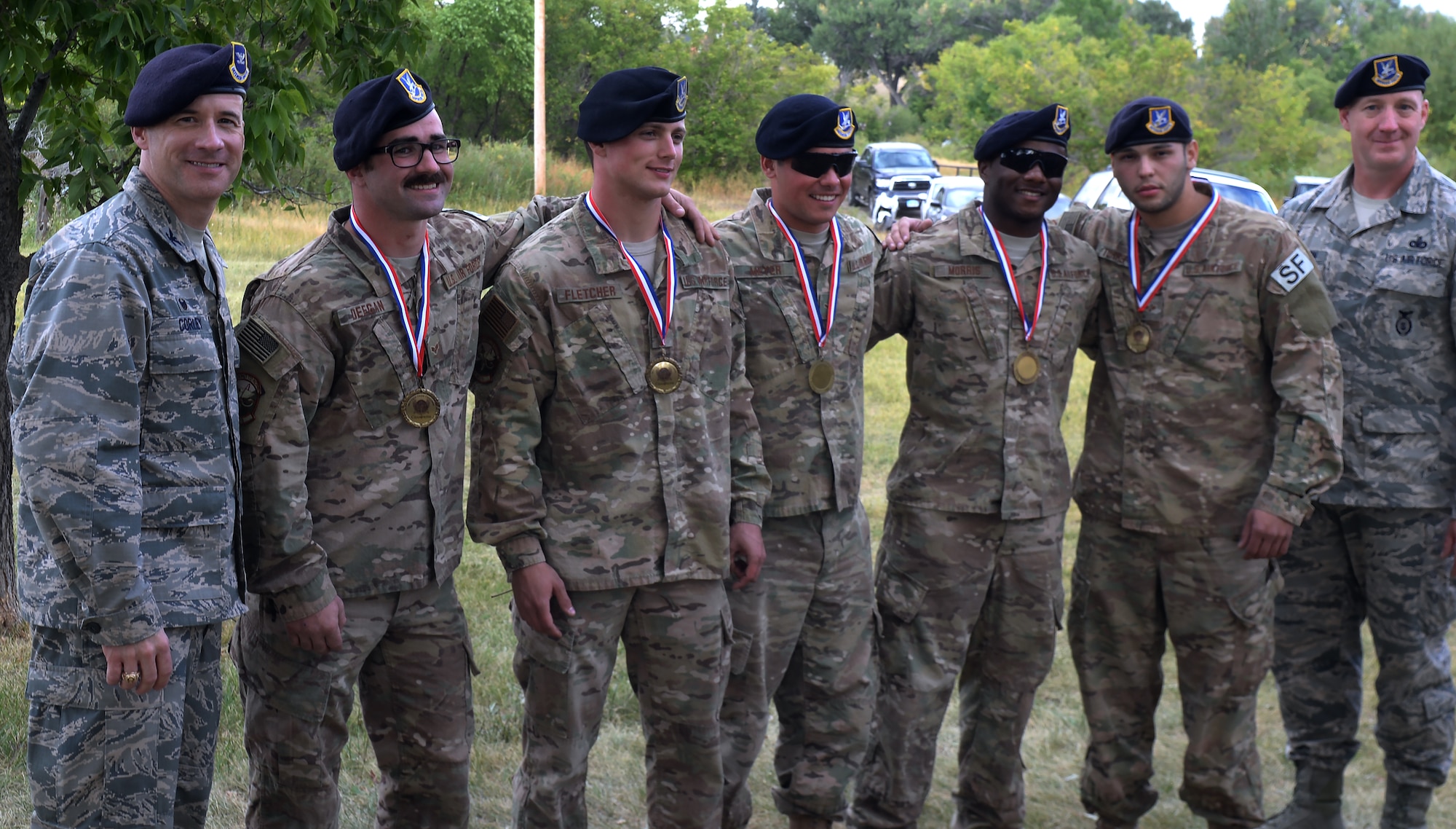 Col. Christopher Corley, 90th Security Forces Group commander, and Chief Master Sgt. Steven Thompson, 90th SFG command chief, pose for a photo with the 2015 Crow Creek Challenge winners Sept. 11, 2015, on F.E. Warren Air Force Base, Wyo. This is the 21st Annual Crow Creek Challenge. (U.S. Air Force photo by Airman 1st Class Brandon Valle)