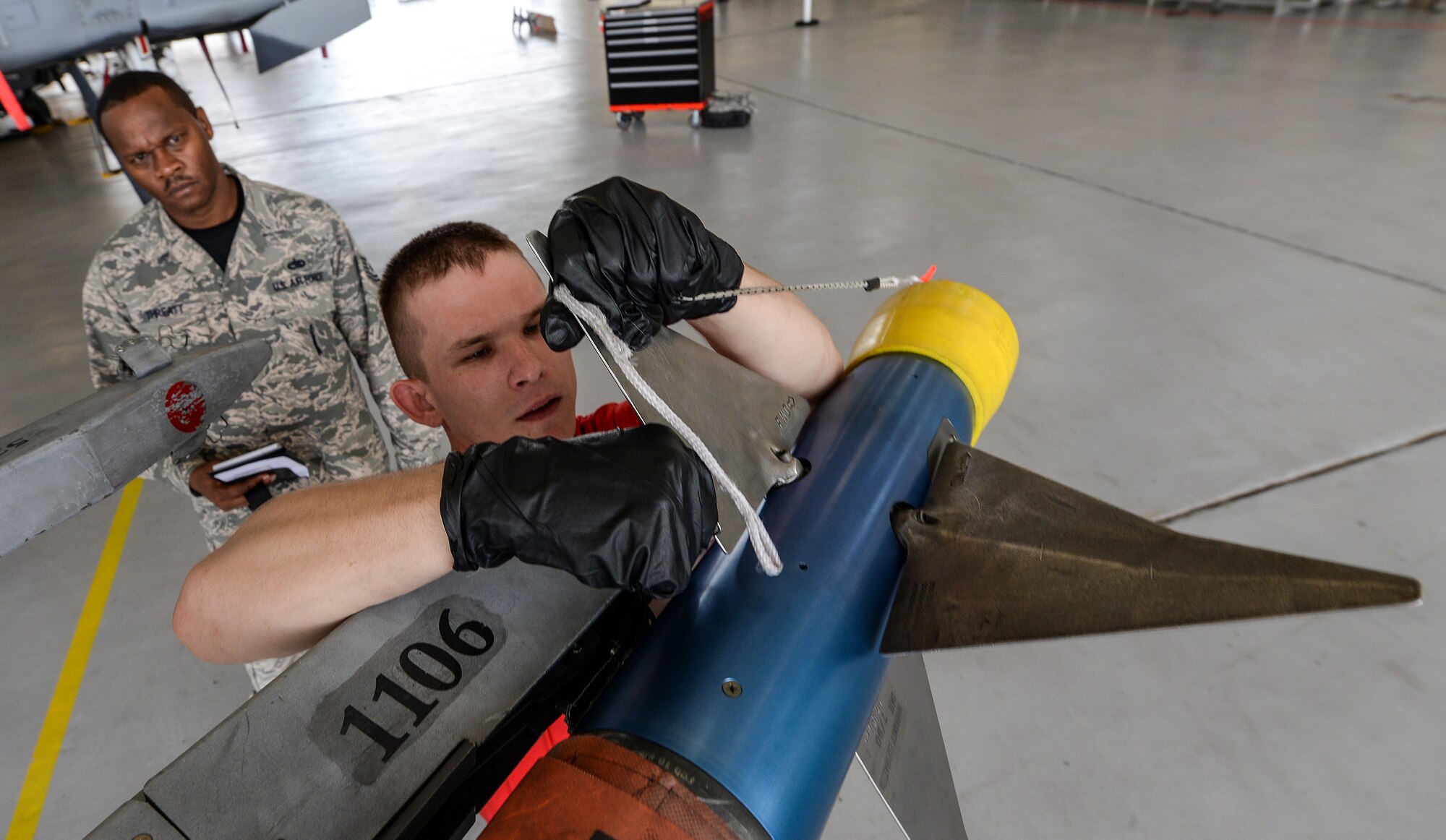 U.S. Air Force Airman 1st Class Matthew Leammon, 75th Aircraft Maintenance Unit  weapons load member, secures an inert AIM-9 air to air missile onto an A-10C Thunderbolt II, during a weapons load competition Sept. 11, 2015, at Moody Air Force Base, Ga.  The 74th AMU won the competition this quarter, defeating the 75th AMU, teams are chosen based on weapons loading and maintenance performance during the previous quarter. (U.S. Air Force photo by Airman 1st Class Janiqua P. Robinson/Released) 