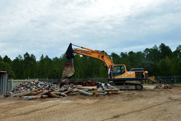 A machine used by contractors cuts up munitions in the residue area as part of a de-milling process at Poinsett Electronic Combat Range, Wedgefield, S.C., Aug. 20, 2015. In 2015, after approximately six years of accumulation, the contractors processed 312 tons of munitions and target debris at Poinsett Range with an estimated value of $44,665 to be collected by the Air Force. (U.S. Air Force photo by Senior Airman Diana M. Cossaboom/Released)