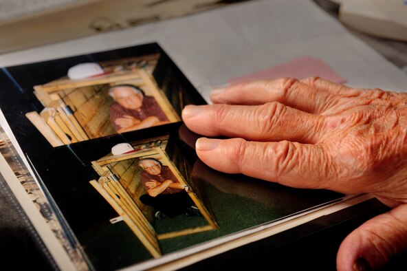 Retired U.S. Army 1st Sgt. Ray Frazier touches a photo of himself at Davis-Monthan Air Force Base, Ariz., Aug. 28, 2015. During the Korean War Frazier was captured by Chinese and North Korean soldiers. During his time as a POW he organized a resistence group within the camp. Soon his captors found out and court martialed him, his punishment was seven months of confinement in a box. (U.S. Air Force photo by Senior Airman Cheyenne A. Powers/Released) 