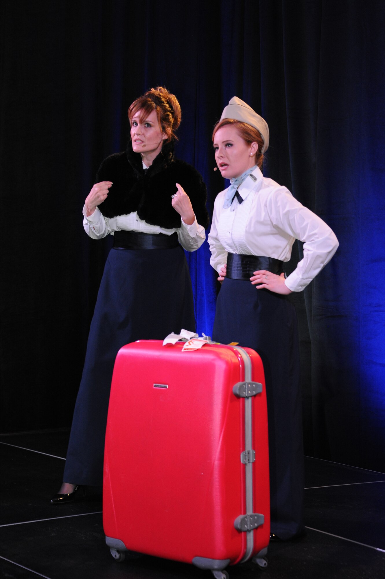 U.S. Air Force Capt. Kathryn Martin, 355th Fighter Wing special victims counsel, and Staff Sgt. Carley Bolitho, 12th Air Force cyber systems administrator, perform during an Air Force Ball at the Tucson Convention Center, in Tucson, Ariz., Sept. 12, 2015. Following the theme “D-M Through Time,” historical events of Davis-Monthan Air Force Base were highlighted through the use of skits and musical numbers. (U.S. Air Force photo by Airman 1st Class Ashley N. Steffen/Released) 
 
