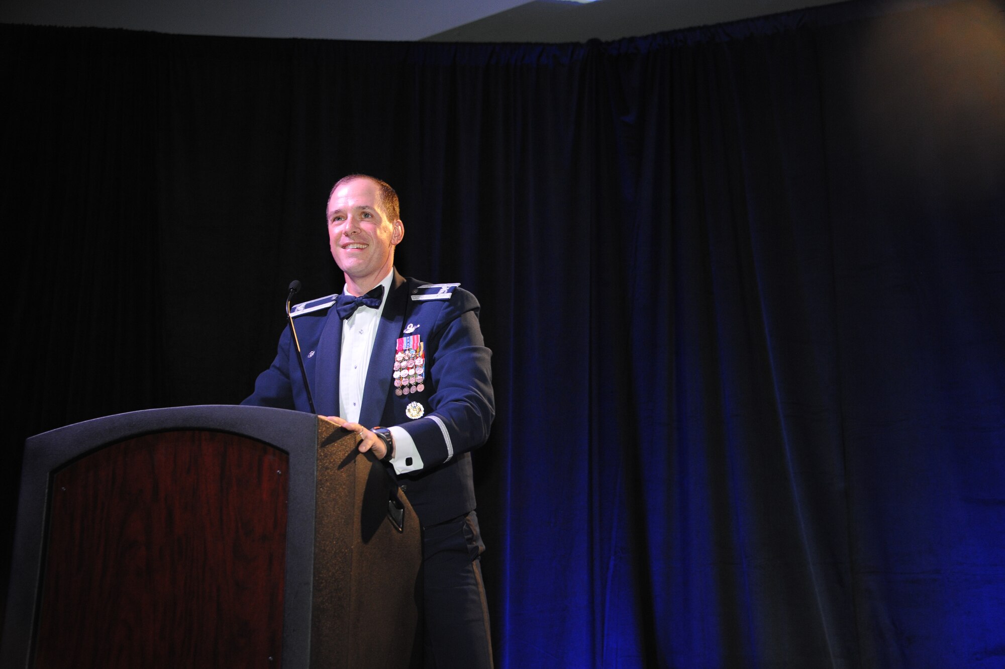 U.S. Air Force Col. James P. Meger, 355th Fighter Wing commander, gives a speech during the Air Force Ball at the Tucson Convention Center, in Tucson, Ariz., Sept. 12, 2015. As the event’s host, Meger spoke and participated in a musical skit featuring the history of Davis-Monthan Air Force Base. (U.S. Air Force photo by Airman 1st Class Ashley N. Steffen/Released)