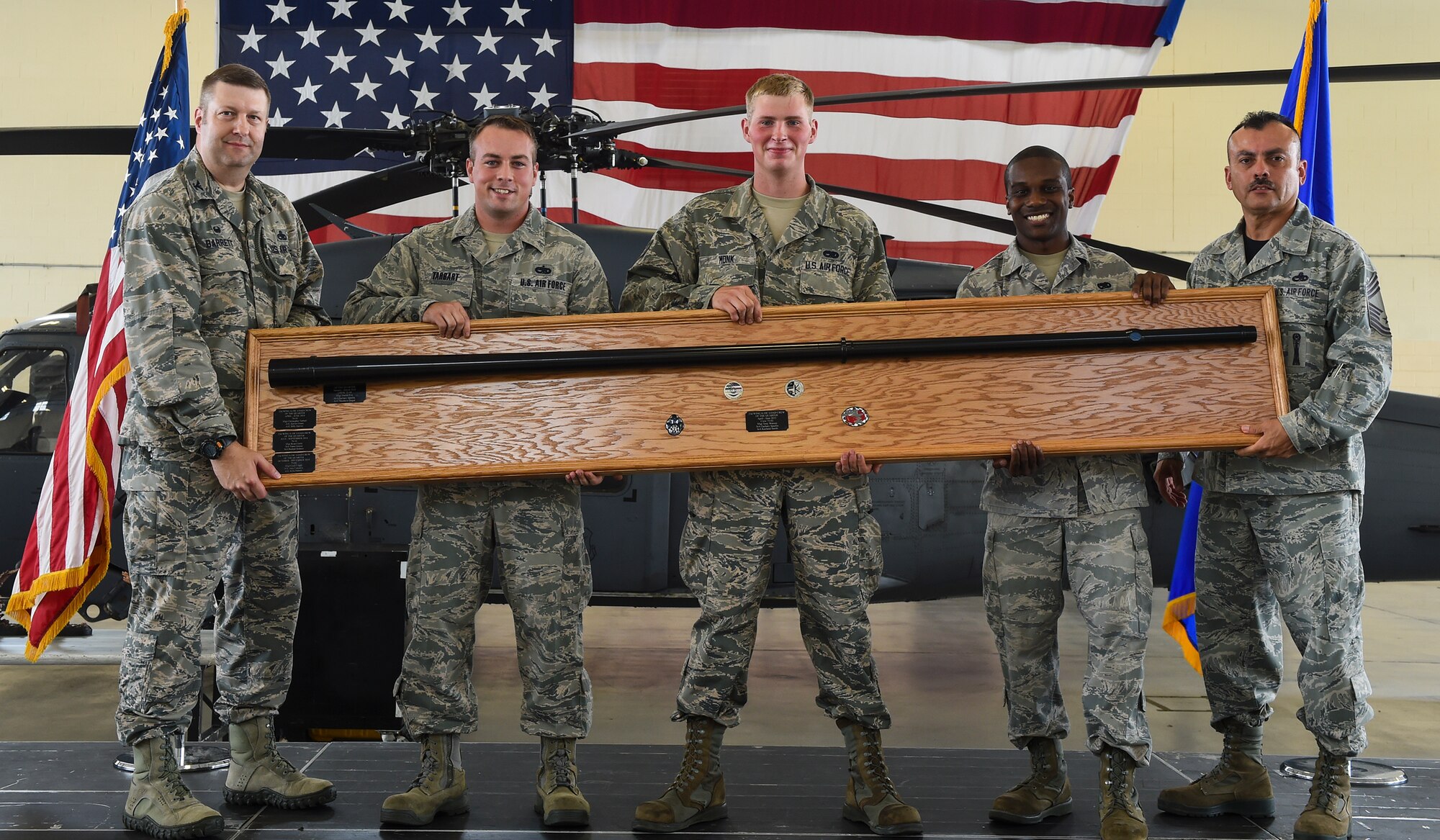 Leadership from the 23d Maintenance Group and weapons load crew members from the 74th Aircraft Maintenance Unit pose for a photo during the load crew of the quarter competition Sept. 11, 2015, at Moody Air Force Base, Ga. The 74th AMU regained the title, trophy and bragging rights of best load crew after losing the first two quarterly competitions to the 75th AMU. (U.S. Air Force photo by Senior Airman Ceaira Tinsley/Released)
