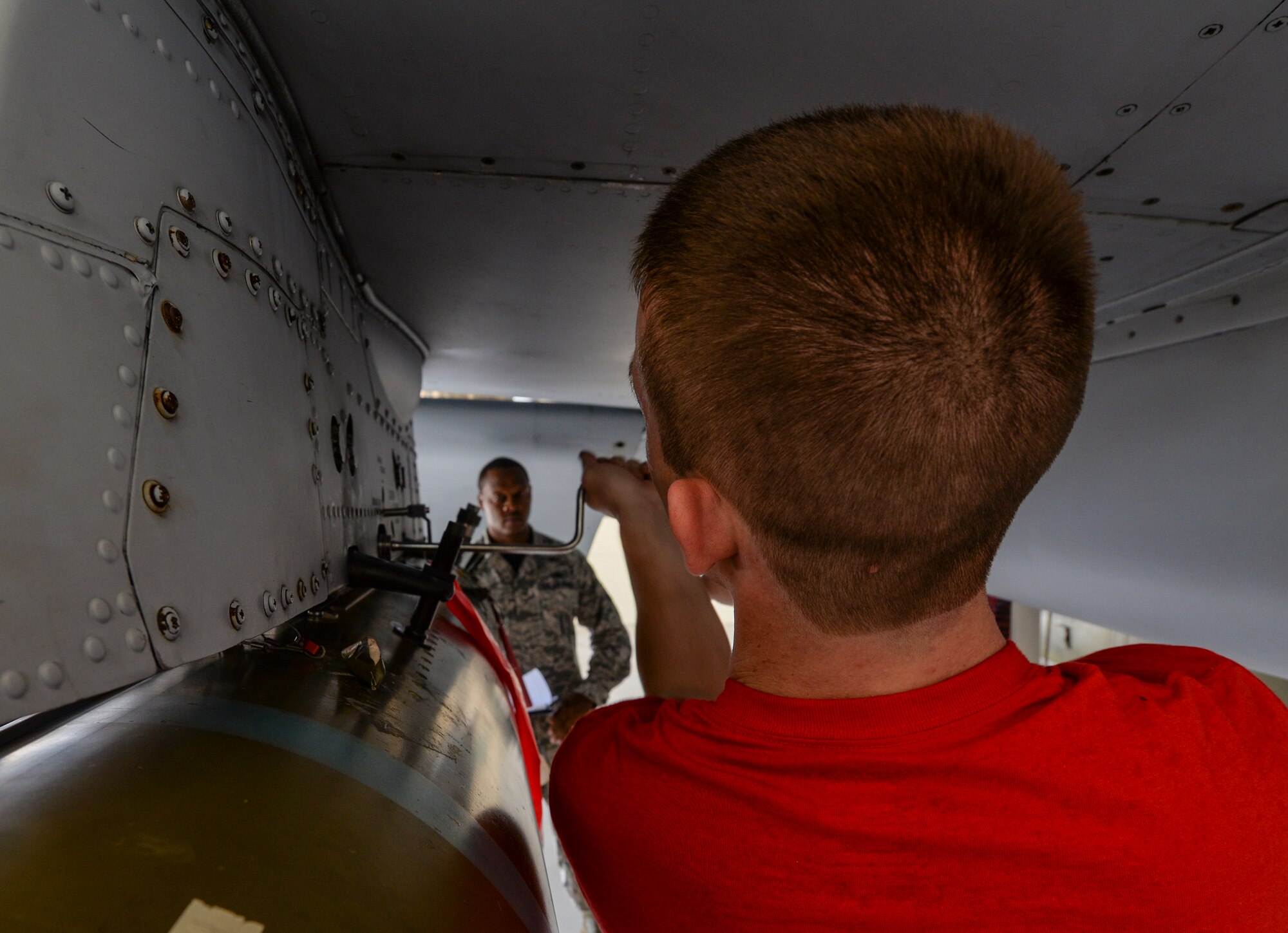 U.S. Air Force Airman 1st Class Matthew Leammon, 75th Aircraft Maintenance Unit weapons load crew member, ensures a MK-84 general purpose bomb is securely installed on an A-10C Thunderbolt II, during a weapons load competition Sept. 11, 2015, at Moody Air Force Base, Ga. The competition is a way for load crews and units to stay determined and focused and keep the rivalry between the 74th and 75th AMU alive. (U.S. Air Force photo by Airman 1st Class Janiqua P. Robinson/Released)