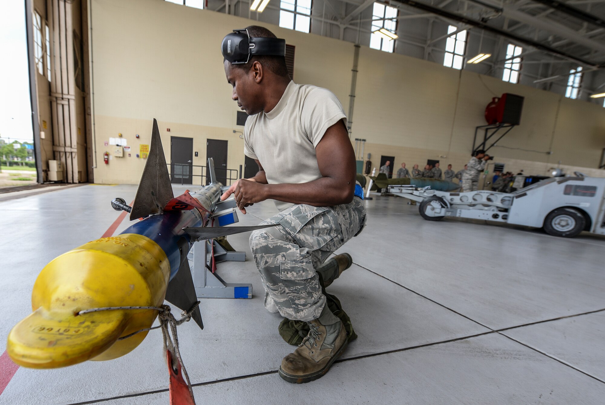U.S. Air Force Senior Airman Tayrell Washington,  74th Aircraft Maintenance Unit weapons load crew member, verifies that an inert AIM-9 air-to- air missile is ready for installation Sept. 11, 2015, at Moody Air Force Base, Ga. In addition to the quarterly competition, load crews are evaluated by weapons standardization every month to ensure they can safely and efficiently load weapons.  (U.S. Air Force photo by Airman 1st Class Janiqua P. Robinson/Released)