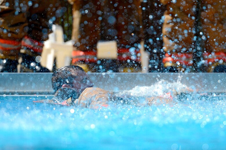 U.S. Air Force Staff Sgt. Christopher Crusius, 20th Civil Engineer Squadron firefighter, surfaces from the water during firefighter water survival training at Shaw Air Force Base, S.C., Sept. 10, 2015. Throughout the training, firefighters learned techniques to stay afloat and practiced swimming while wearing turnout gear in the water. (U.S. Air Force photo by Senior Airman Jensen Stidham/Released)