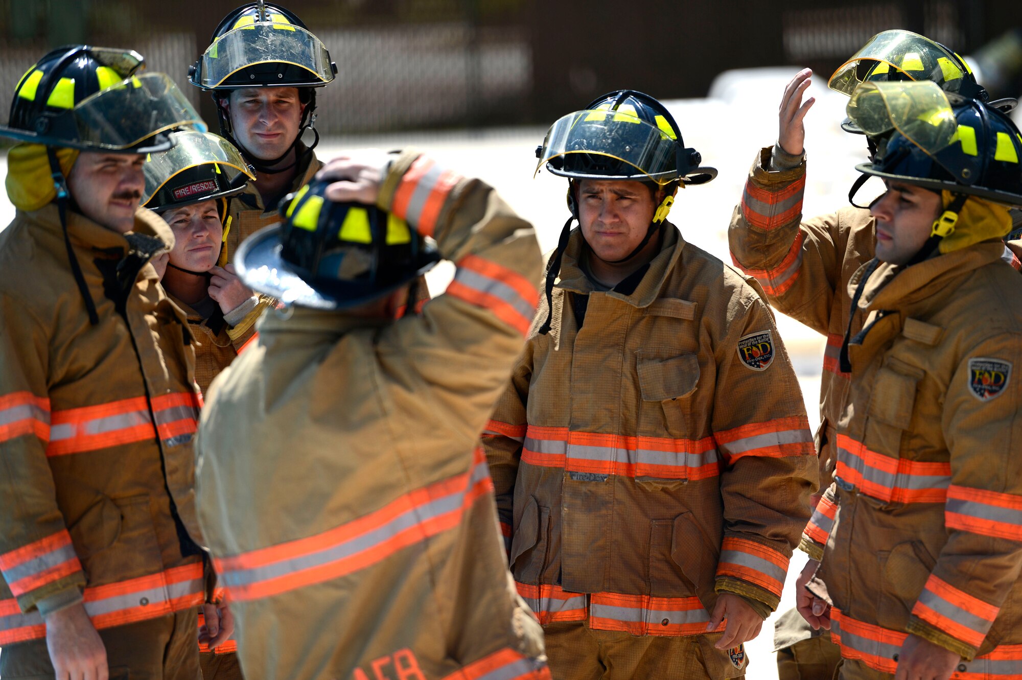 U.S. Air Force firefighters assigned to the 20th Civil Engineer Squadron learn helmet holding techniques during firefighter water survival training at Shaw Air Force Base, S.C., Sept. 10, 2015. In the event that a firefighter enters a body of water with their helmet on, holding the helmet in the correct position could prevent a broken nose. (U.S. Air Force photo by Senior Airman Jensen Stidham/Released)