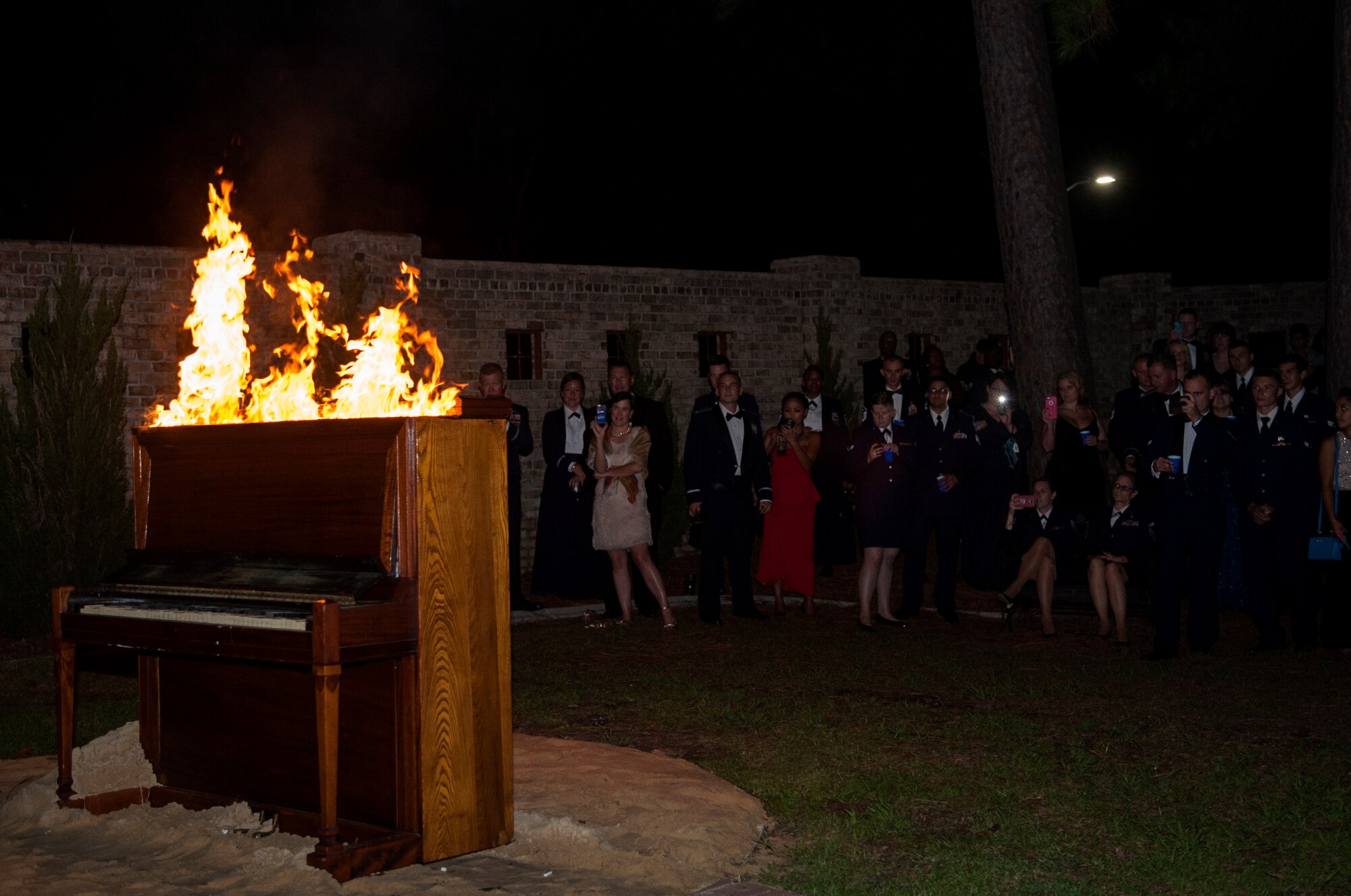 A piano is burned in memoriam of the Battle of Britain during the Air Force Ball, Sept. 12, 2015, at Seymour Johnson Air Force Base, North Carolina. Legend tells of a Royal Air Force pilot and pianist who played during the Battle of Britain. During a mission, the pilot was killed and his comrades decided no one else would play his piano, so they burned it in his memory. (U.S. Air Force photo/Airman 1st Class Shawna L. Keyes)
