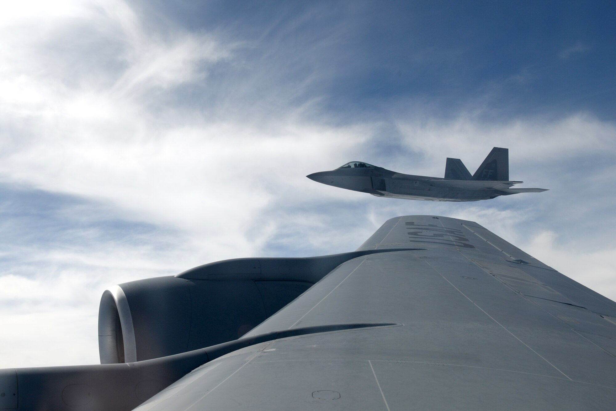An F-22 Raptor soars alongside a KC-135R Stratotanker during Exercise Razor Talon, Sept. 11, 2015. The F-22 Raptor joined aircraft and other support units from multiple bases along the East Coast to conduct training missions designed to promote synergy between forces. (U.S. Air Force photo/Airman 1st Class Ashley Williamson)