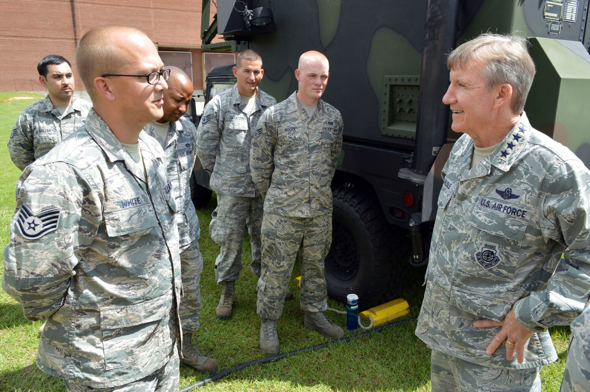 U.S. Air Force Gen. Hawk Carlisle, commander of Air Combat Command, receives a mission briefing from Staff Sgt. Kerry White, a heating, ventilation, air conditioning and refrigeration technician assigned to the 682nd Air Support Operations Squadron, on how he provides power production for an air support operations center. Carlisle visited 18th Air Support Operations Group battlefield Airmen at Pope Army Airfield, North Carolina, Sept. 9. (U.S. Air Force photo/Marvin Krause)