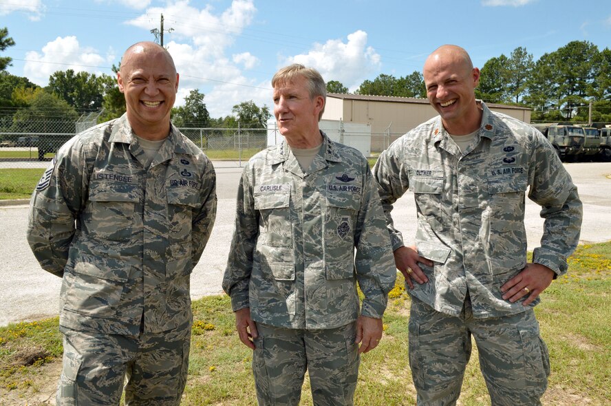 U.S. Air Force Senior Master Sgt. Blaine Listenbee, left, and Maj. Douglas Oltmer, right, both assigned to the 18th Weather Squadron, share a lighthearted moment with Gen. Hawk Carlisle, commander of Air Combat Command, during Carlisle’s visit with their unit at Pope Army Airfield, North Carolina, Sept. 9. (U.S. Air Force photo/Marvin Krause)