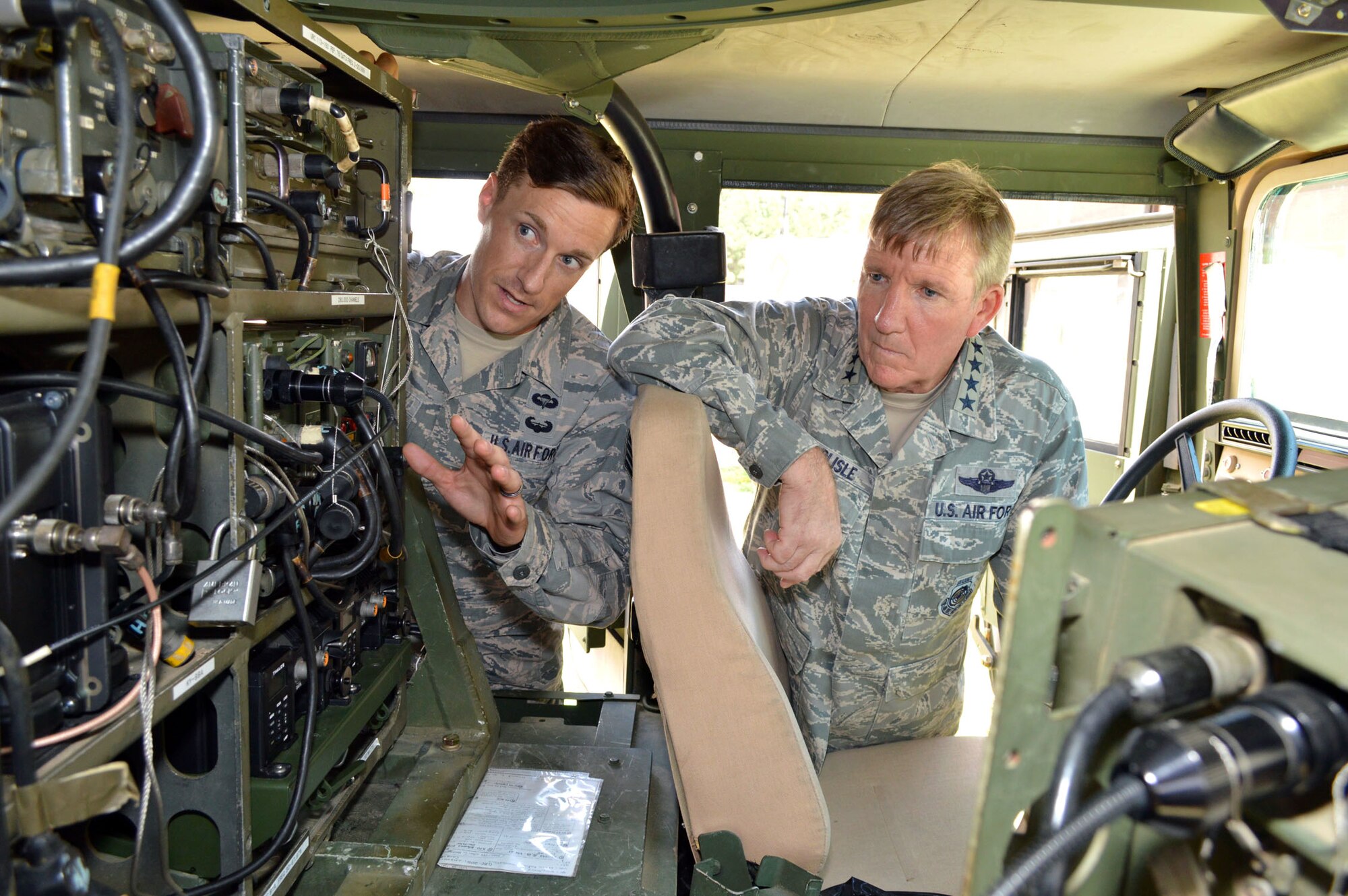 U.S. Air Force Staff Sgt. James Demars II, a tactical air control party specialist assigned to the 14th Air Support Operations Squadron, briefs Gen. Hawk Carlisle, commander of Air Combat Command, about tactical communications equipment mounted in a High Mobility Multipurpose Wheeled Vehicle. Carlisle visited 18th Air Support Operations Group battlefield Airmen at Pope Army Airfield, North Carolina, Sept. 9. (U.S. Air Force photo/Marvin Krause)