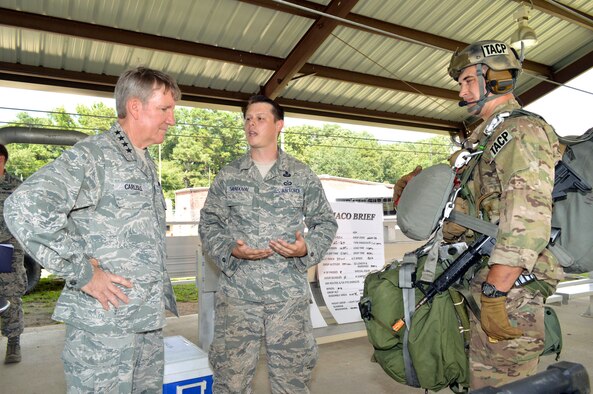 U.S. Air Force Staff Sgt. Jason Sandoval, a tactical air control party specialist assigned to the 14th Air Support Operations Squadron, briefs Gen. Hawk Carlisle, commander of Air Combat Command, about tactical air control party equipment worn by Senior Airman Matthew Wilson, a tactical air control party specialist assigned to the 14th Air Support Operations Squadron. Carlisle visited 18th Air Support Operations Group battlefield Airmen at Pope Army Airfield, North Carolina, Sept. 9. (U.S. Air Force photo/Marvin Krause)