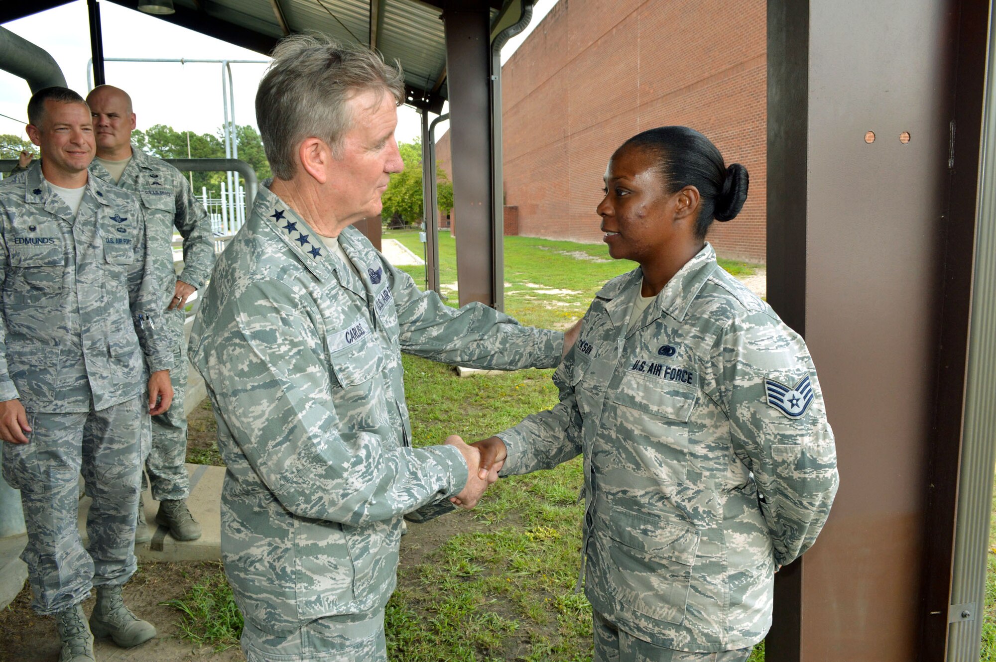 U.S. Air Force Gen. Hawk Carlisle, commander of Air Combat Command, presents his commander’s coin to Staff Sgt. Melissa Jackson, a supply specialist assigned to the 14th Air Support Operations Squadron, recognizing her outstanding duty performance. Carlisle visited 18th Air Support Operations Group battlefield Airmen at Pope Army Airfield, North Carolina, Sept. 9. (U.S. Air Force photo/Marvin Krause)