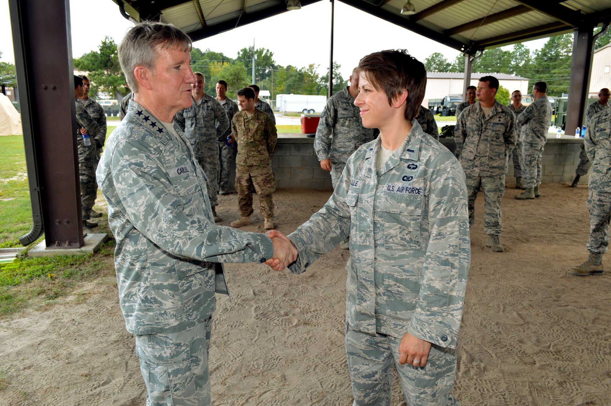 U.S. Air Force Gen. Hawk Carlisle, commander of Air Combat Command, shakes hands with 1st Lt. Caitlin Valle, the first female tactical air control party officer in the U.S. Air Force during his visit with battlefield Airmen assigned to the 18th Air Support Operations Group, Pope Army Airfield, North Carolina, Sept. 9. (U.S. Air Force photo/Marvin Krause)