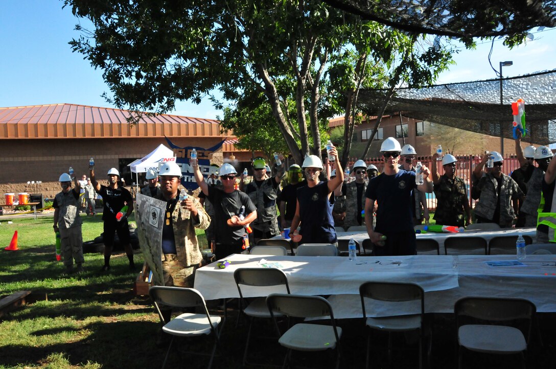 Airmen from the 161st Air Refueling Wing lift their water bottles for a toast at the wing’s first ever combat dining-in, Sept. 12, 2015, at Phoenix Sky Harbor Air National Guard Base. The combat dining in is a time-honored Air Force tradition that is making its way back into units across the Air National Guard. (U.S. Air National Guard photo by Master Sgt. Kelly Deitloff)