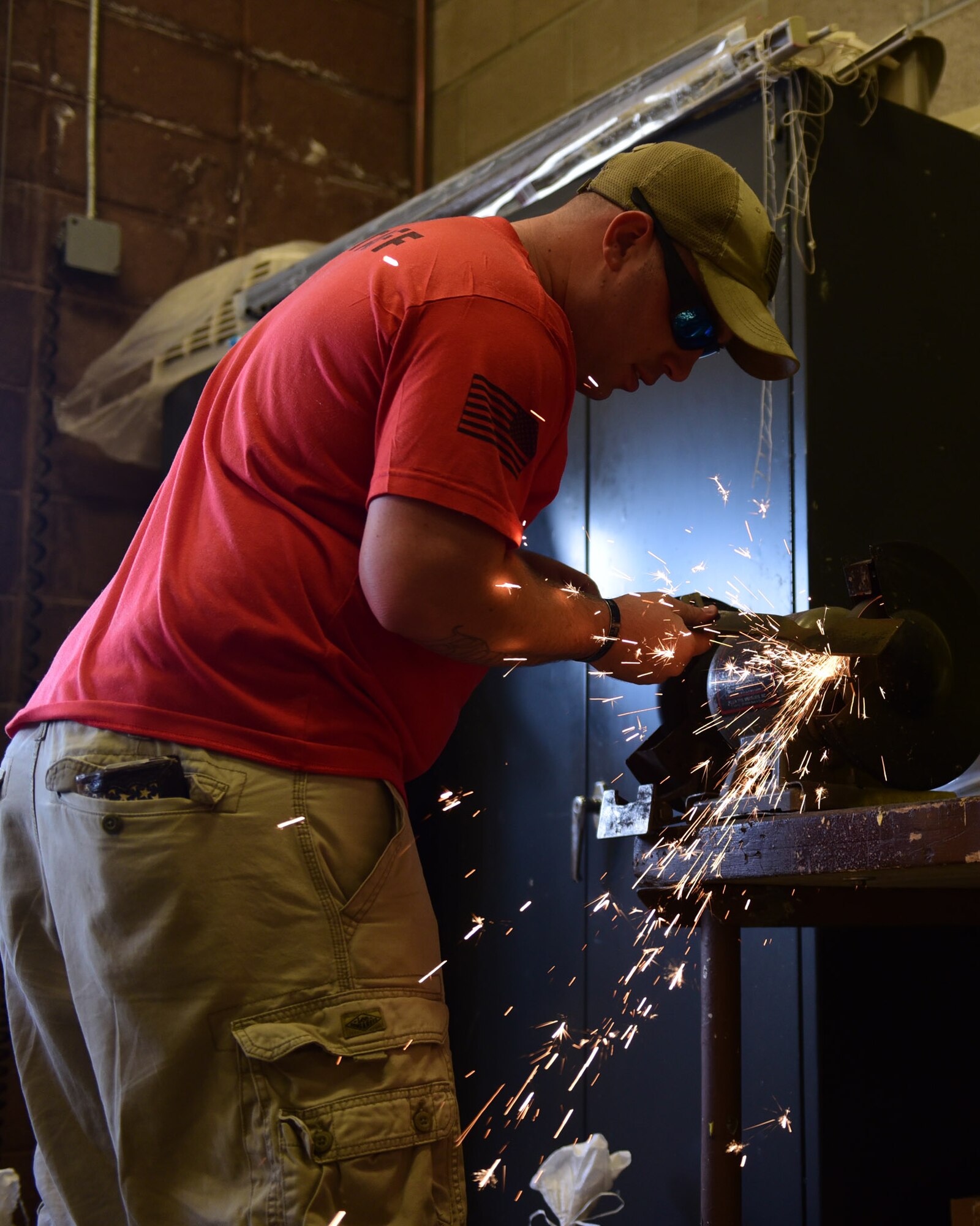 TJ Binder, 28th Force Support Squadron outdoor recreation technician, sharpens a lawnmower blade for a customer at the Outdoor Recreation Center at Ellsworth Air Force Base, S.D., Sept. 11, 2015. Sharpening lawnmower blades is just one of the many services offered by the center, for a full list go to www.ellsworthfss.com. (U.S. Air Force photo by Airman 1st Class James L. Miller/Released)   