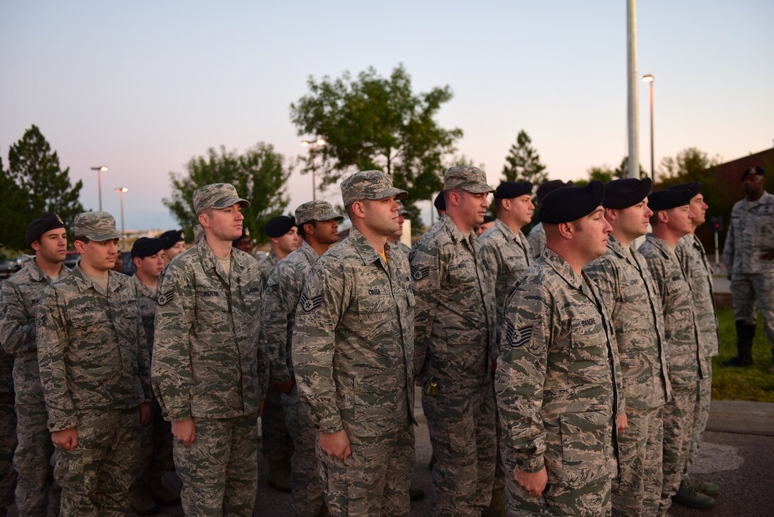 Ellsworth Airmen stand in formation for a 9/11 Memorial Ceremony at Ellsworth Air Force Base, S.D., Sept. 11, 2015. Airmen, families and first responders from surrounding communities gathered to recognize and honor the nearly 3,000 lives lost 14 years ago. (U.S. Air Force photo by Airman 1st Class James L. Miller/Released)