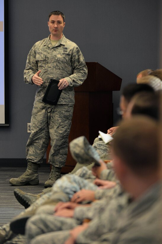 Master Sgt. Mark Masse, Headquarters Air Combat acquisitions and financial program manager, speaks with maintenance Airmen at Ellsworth Air Force Base, S.D., Sept. 9, 2015. Following a recent Air Force initiative aimed to increase effectiveness, all ACC bases have transitioned to using iPads for technical order use. (U.S. Air Force photo by Senior Airman Rebecca Imwalle/Released)