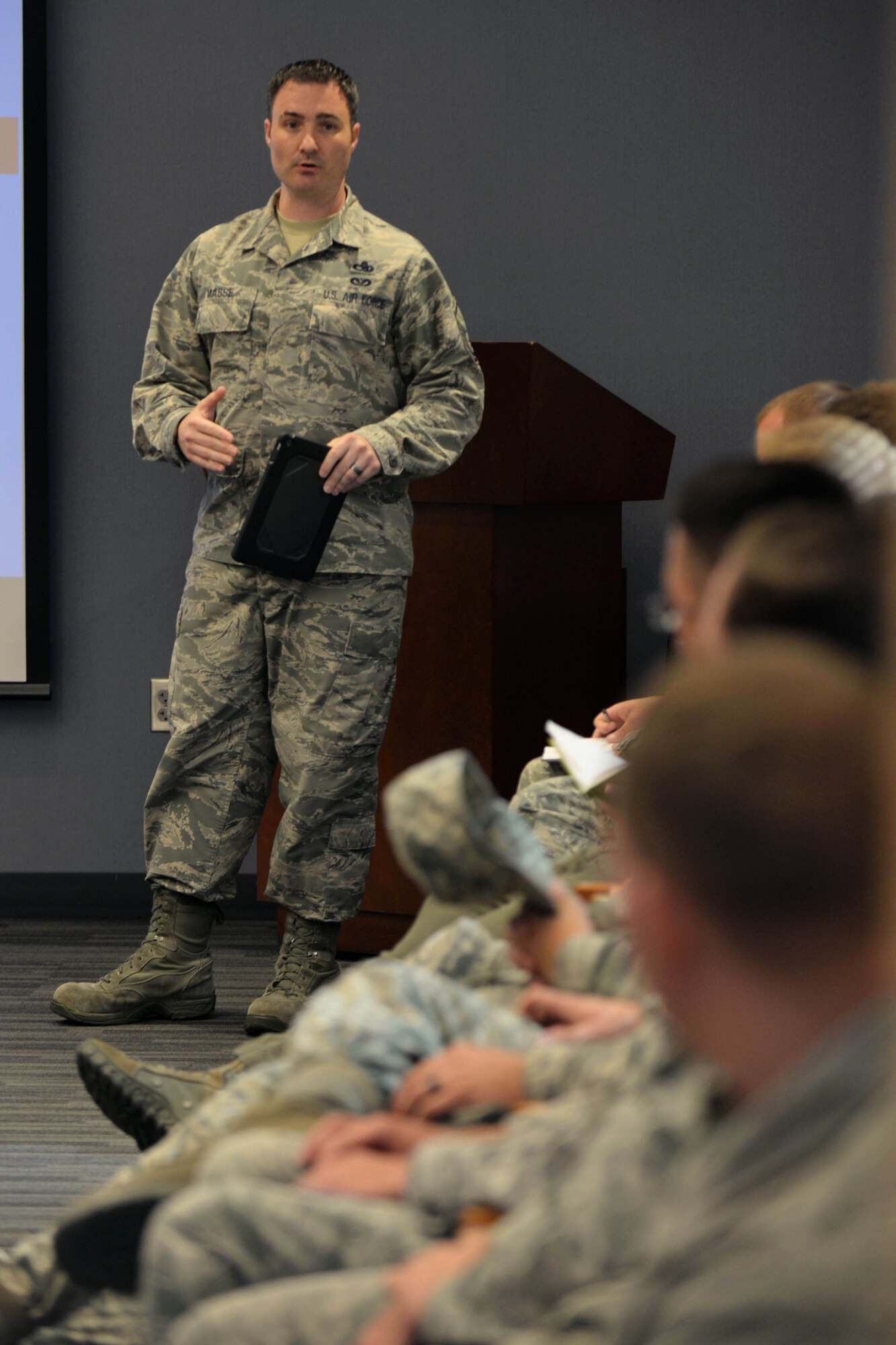 Master Sgt. Mark Masse, Headquarters Air Combat acquisitions and financial program manager, speaks with maintenance Airmen at Ellsworth Air Force Base, S.D., Sept. 9, 2015. Following a recent Air Force initiative aimed to increase effectiveness, all ACC bases have transitioned to using iPads for technical order use. (U.S. Air Force photo by Senior Airman Rebecca Imwalle/Released)