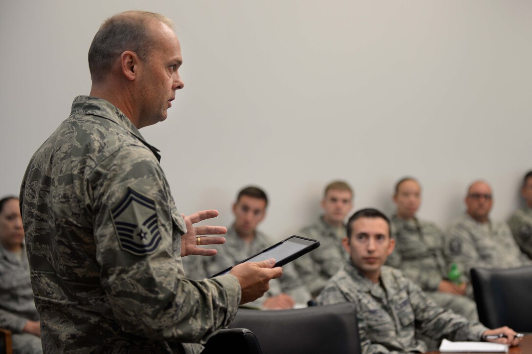 Senior Master Sgt. Edward Dierkens, Headquarters Air Combat Command superintendent of maintenance integration, informs Airmen on the capabilities of the newly implemented iPads at Ellsworth Air Force Base, S.D., Sept. 9, 2015. Air Combat Command bases have fully transitioned to using iPads to conduct daily operations, replacing the toughbooks which were previously used. (U.S. Air Force photo by Senior Airman Rebecca Imwalle/Released)